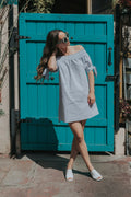 Woman in a casual summer top with a warm, sunlit portrait style — placeholder image