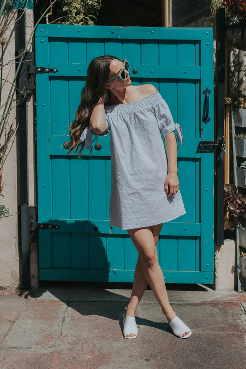 Woman in a casual summer top with a warm, sunlit portrait style — placeholder image