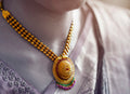 Woman wearing gold and silver rings and necklace, stacking ring reference — placeholder image