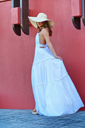 Woman in a blue and white off-shoulder-style top with a yellow sun hat — placeholder image