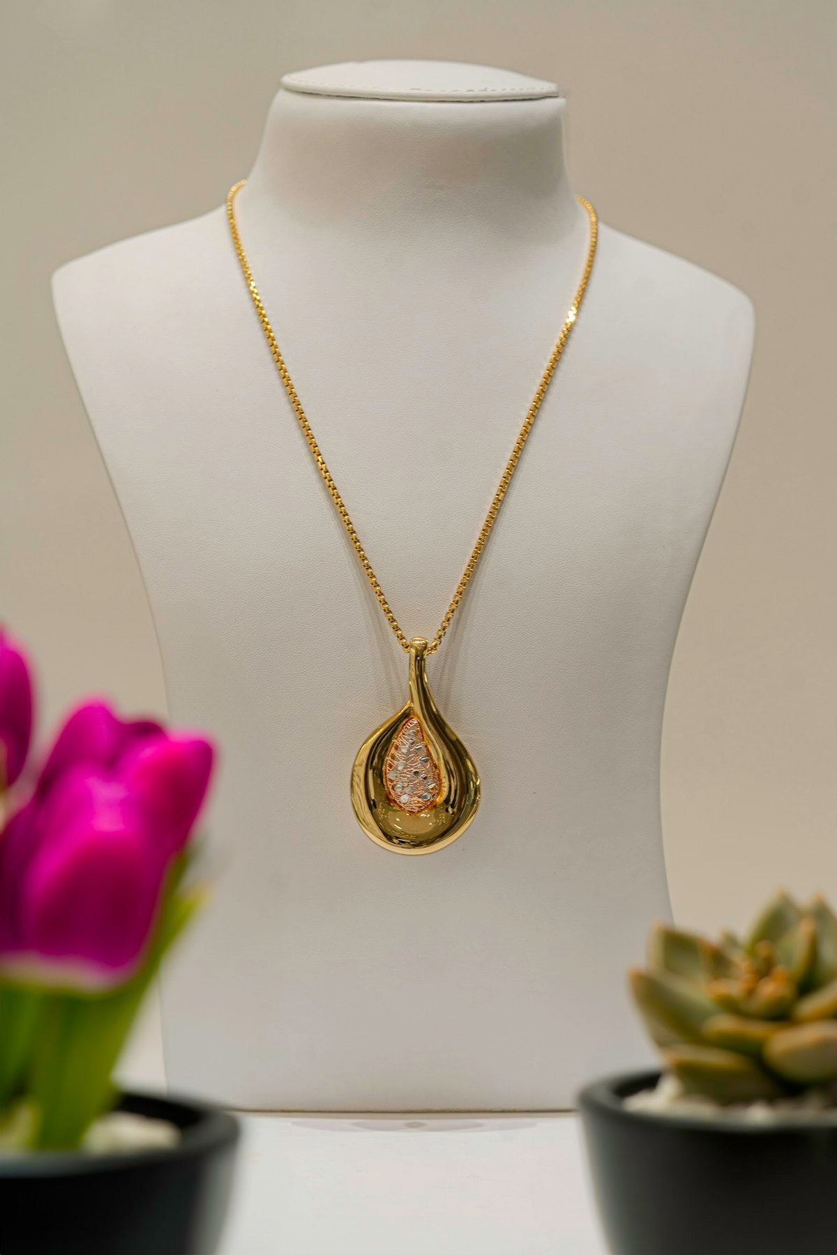 Necklace displayed on a mannequin with soft floral background, pearl-style jewelry reference — placeholder image