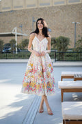Woman in a red floral resort outfit standing on a farm, warm summer styling — placeholder image